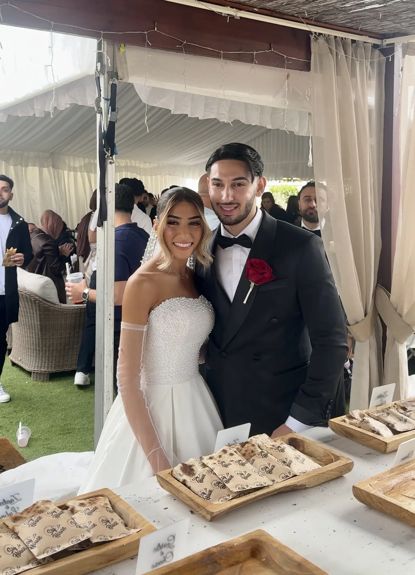 Bride and groom smiling at their wedding reception.