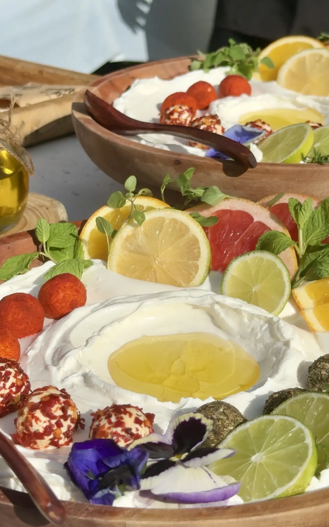 A vibrant platter with lemon wedges and dips.